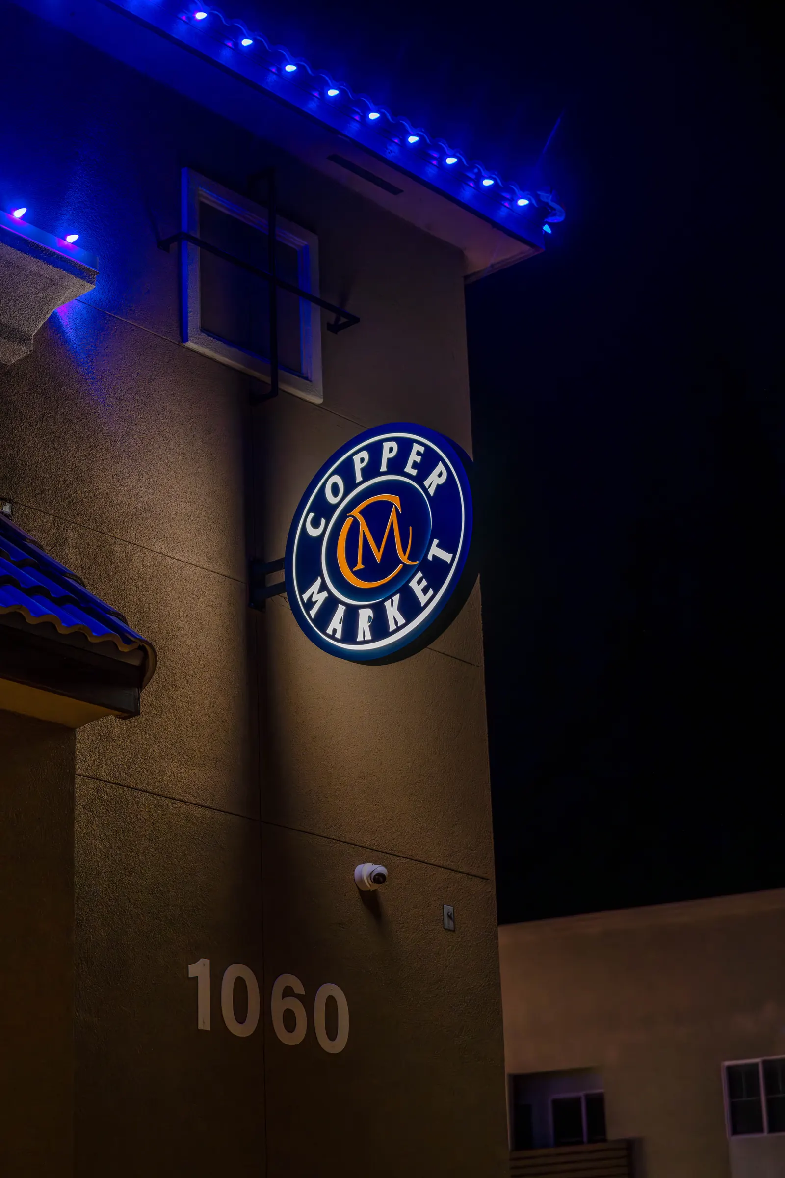 Blade sign on a tower at night