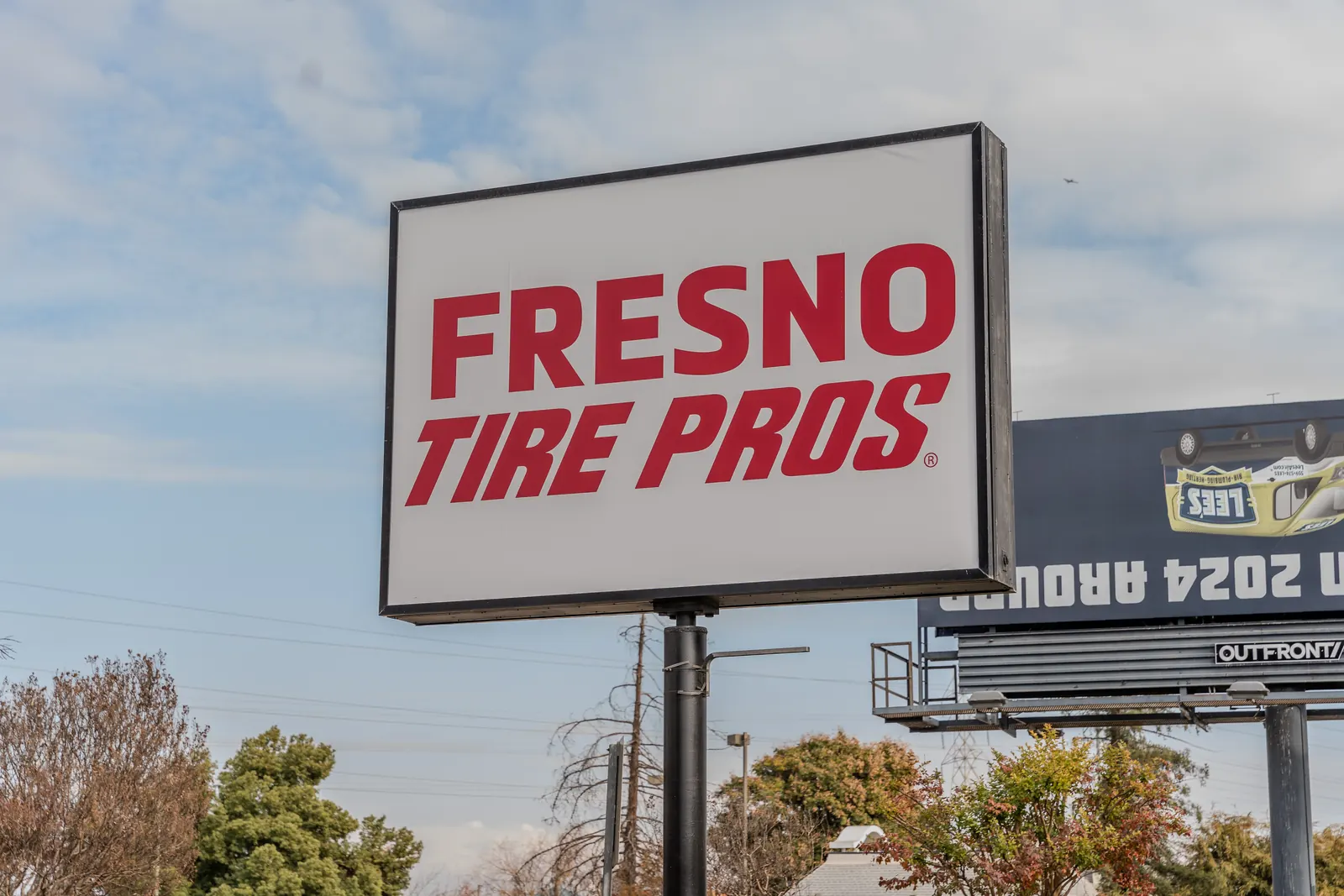 Fresno Tire Pros pylon sign standing tall against the sky