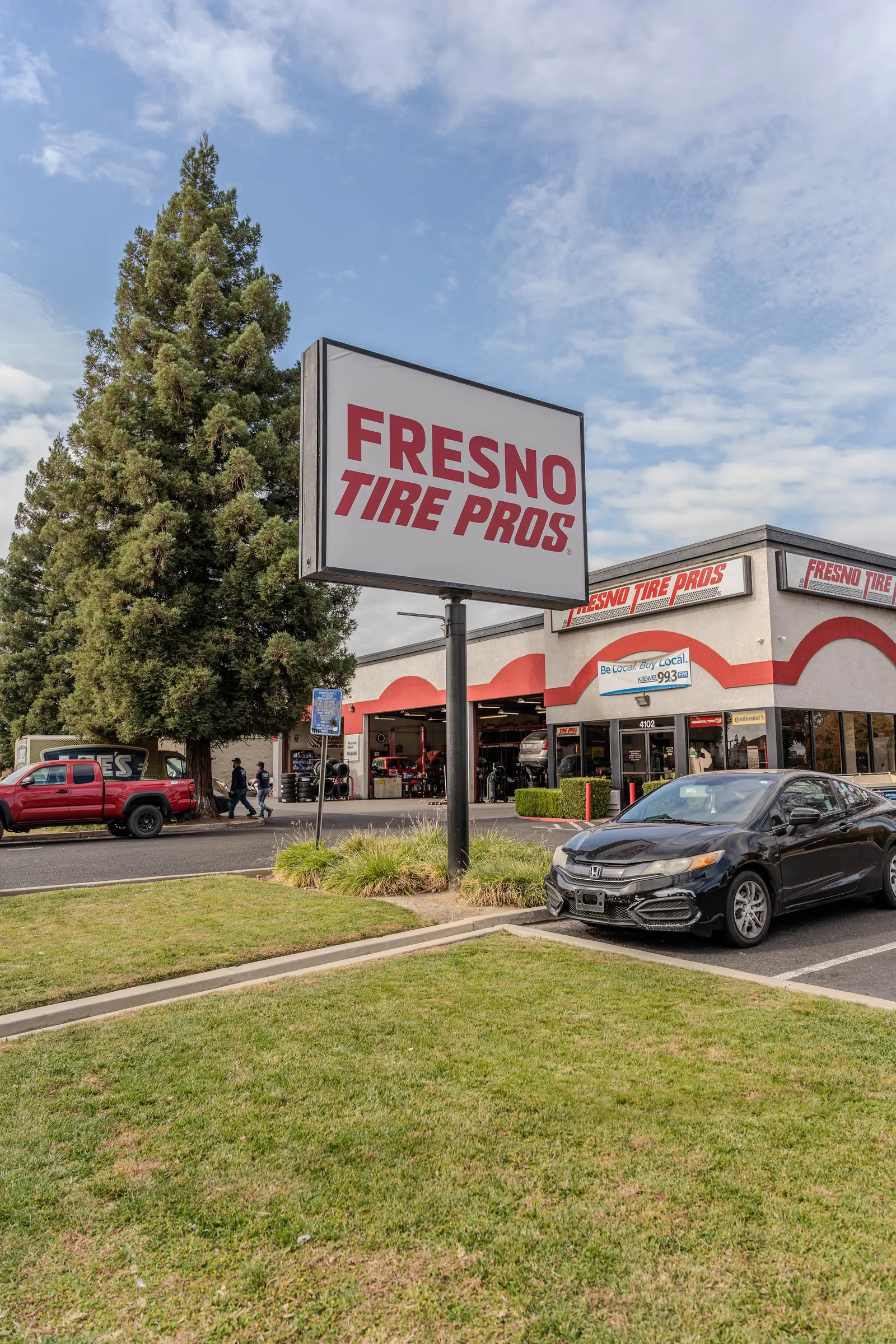 Tall roadside pylon sign for Fresno Tire Pros