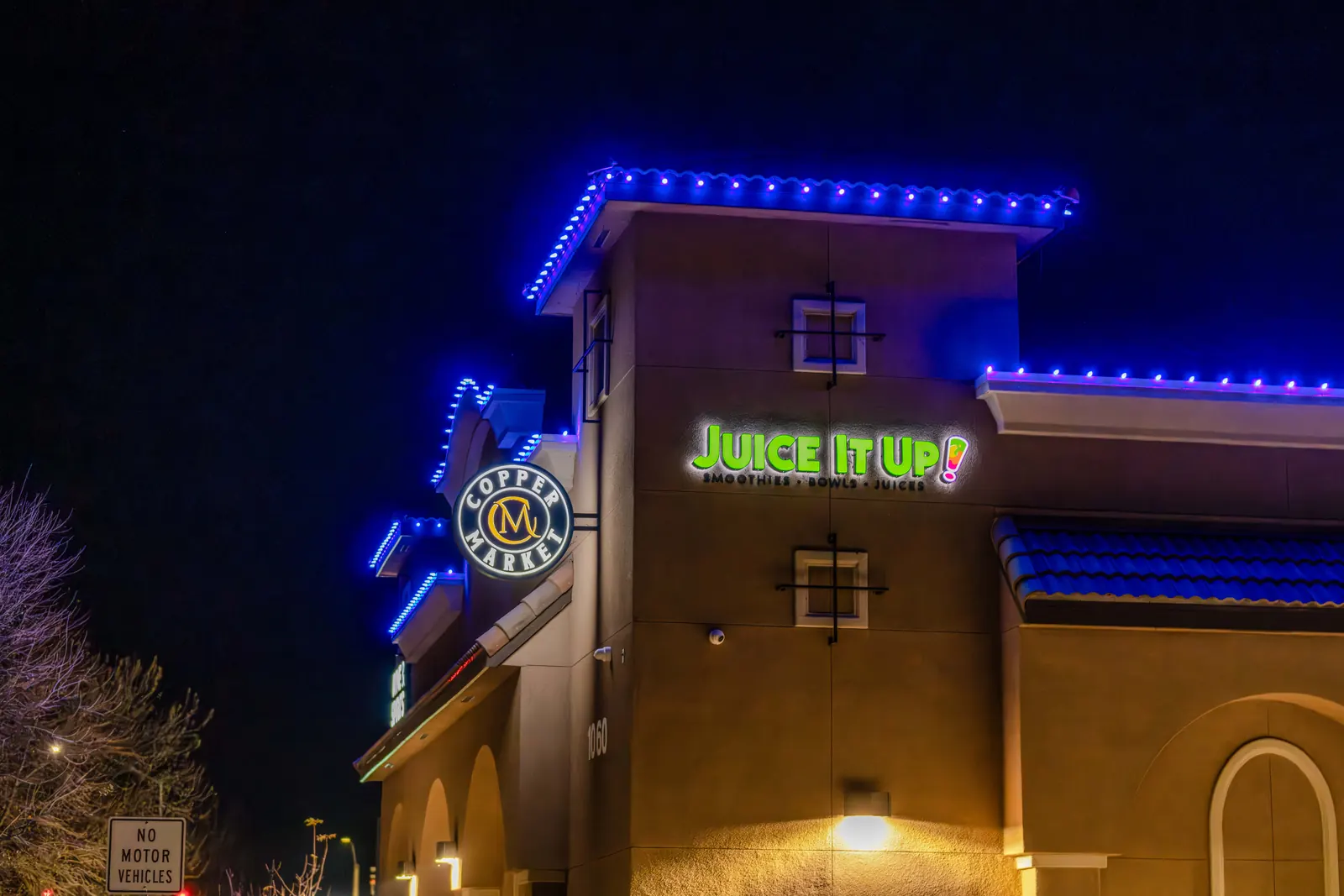 Juice It Up LED backlit sign glowing at night