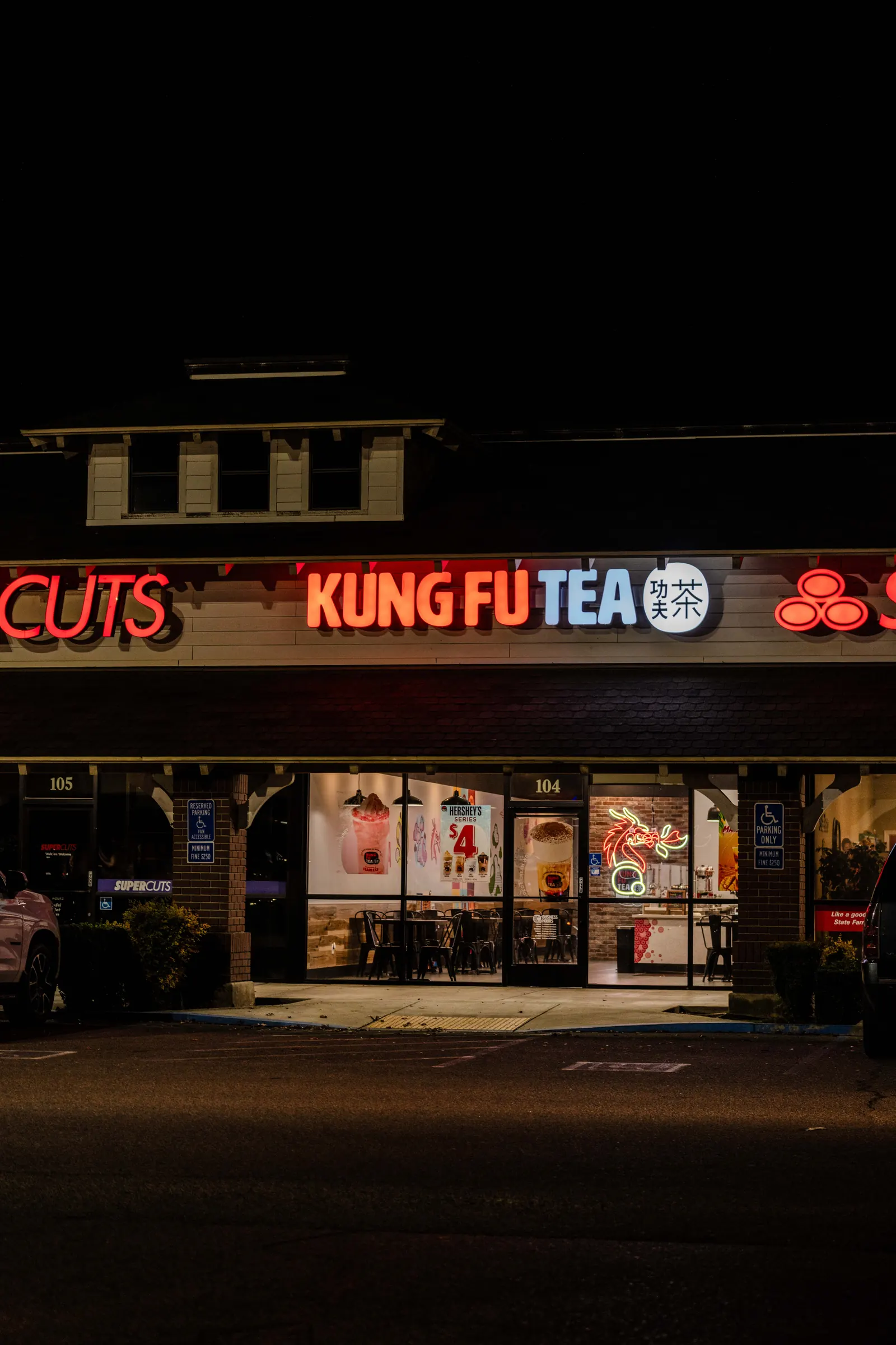 Illuminated channel letter signs on a storefront at night